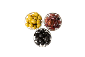 Green, black and red olives isolated on white background. Various types of olives and with fresh olive leaves. Mediterranean food. Vegan.