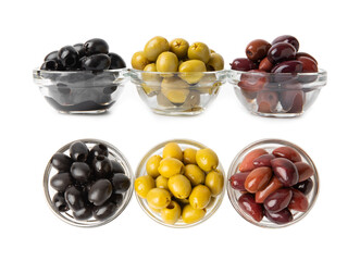 Green, black and red olives isolated on white background. Various types of olives and with fresh olive leaves. Mediterranean food. Vegan.