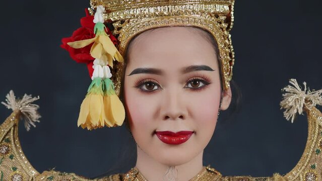 Beautiful Asian woman wear Thai traditional dress action of Thai classical dancing.