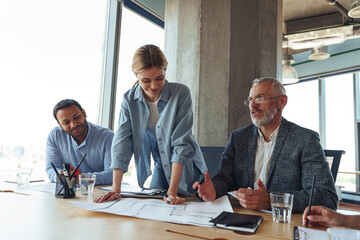 Team of business investors is discussing a new project in modern office. Concept of financing