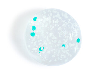 smears and drops of transparent gel with blue granules. On a white background.