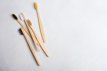 Eco-friendly bamboo toothbrushes on grey background