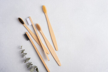 Eco-friendly bamboo toothbrushes on grey background