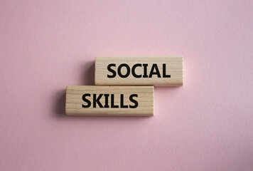 Social skills symbol. Wooden blocks with words Social skills Beautiful pink background. Business and Social skills concept. Copy space.