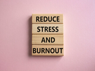 Reduce Stress and Burnout symbol. Concept word Reduce Stress and Burnout on wooden blocks. Beautiful pink background. Business and Reduce Stress and Burnout concept. Copy space