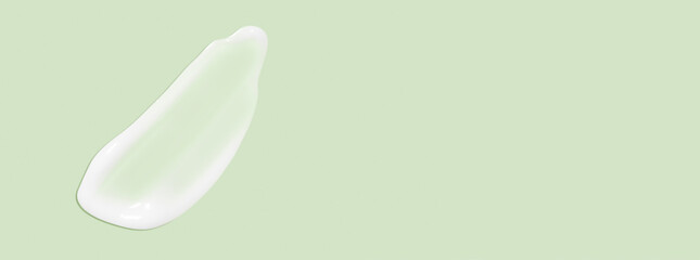 The flowing cream on a green background. Smudged flowing smear of cosmetic cream.