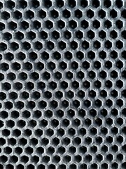 gray hexagonal perforated foam carpet with linear perspective and selective focus, texture and background