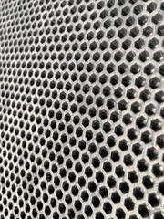 gray hexagonal perforated foam carpet with linear perspective and selective focus, texture and background