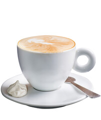 White cup with cappuccino on a saucer and a small candy
