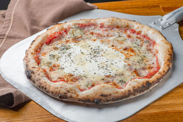 Pizza margarita with tomato sauce, tomatoes melted cheese and oregano spice