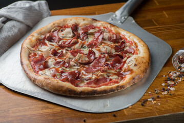 Pizza with salami, ham, sausage and tomato sauce