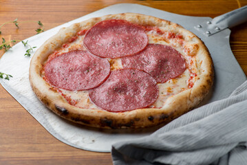 Pizza with salami, sausage and tomato sauce.