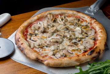 Pizza with mussels, seafood and mushrooms with melted cheese. - 645961835