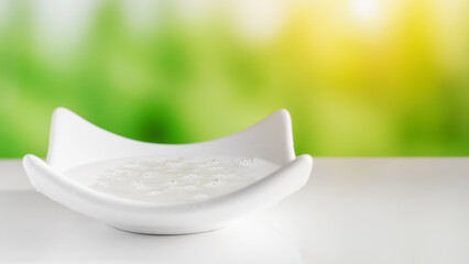 Transparent cosmetic gel in a white bowl.