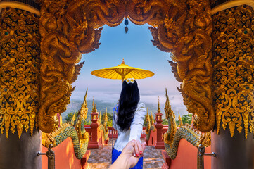 .Asian female tourists watch the sunrise accompanied by fog at Wat Phra That Doi Phrachan, Mae Tha...