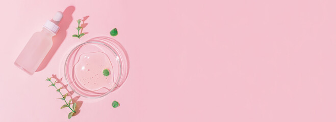 Cosmetic jar with a white cap and a pipette on a pink background. Petri dish with gel on a pink background. Surrounded by plants.
