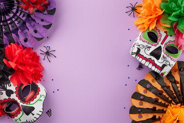 Embrace the festive spirit of Day of the Dead. Top view shot of traditional masks with flowers, paper fans, spooky spiders, cobwebs, confetti on purple background with ad space