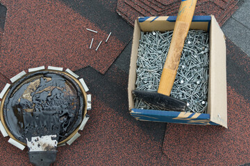 a set of tools for repairing soft tiles, nails and a hammer
