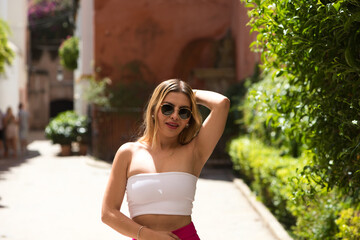 Young and beautiful brunette woman with blonde and latin hair is on holiday in seville. The woman...