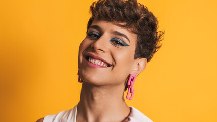 Transgender woman in make up posing while smiling at the camera - obrazy, fototapety, plakaty