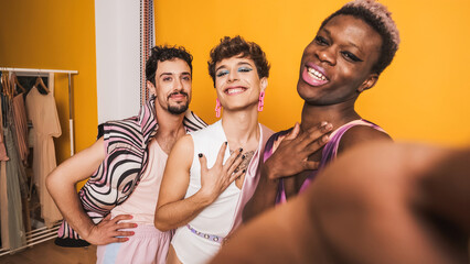 Trans men posing and smiling while taking selfie in a photographic studio - obrazy, fototapety, plakaty