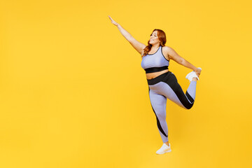 Fototapeta na wymiar Full body side view young chubby plus size big fat fit woman wear blue top warm up train do stretch exercise for hand and leg isolated on plain yellow background studio home gym Workout sport concept