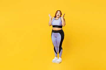 Fototapeta na wymiar Full body shocked young plus size big fat fit woman wears blue top warm up train stand on scales check result spread hands isolated on plain yellow background studio home gym. Workout sport concept.