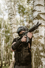 Fototapeta premium Soldier aiming to the target, and ready to shoot.