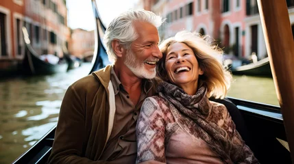 Fotobehang Happy mature couple on a gondola trip during a vacation. Concept of travel, tourism and sightseeing at a senior age, enjoying retirement. Shallow field of view. © henjon