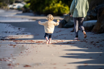 little girl child running on the beach at the seaside