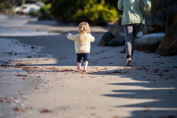 little girl child running on the beach at the seaside