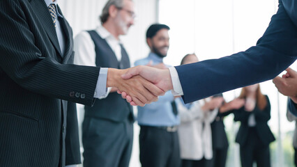 Close up shaking hands of business people close deal making agreement after successful meeting....