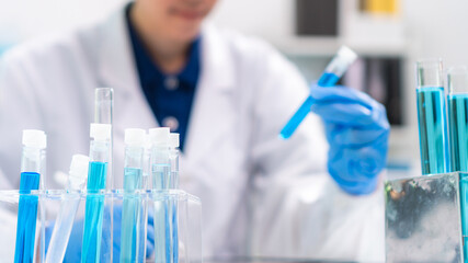 Fototapeta premium Scientist wearing glassware research in chemistry laboratory for pharmaceutical using beaker and test tube equipment for analysis microbiology
