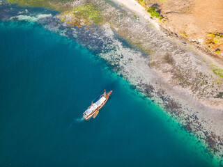 Boats from air. Aerial view on sea in Kelapa Island, Indonesia. Summer seascape with clear water in sunny day. Top view of boats from drone. Summer seascape from air. Travel - image