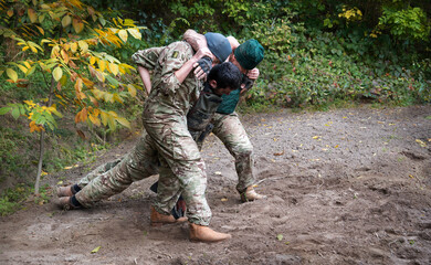 Fototapeta premium The medical workers carries a wounded soldier