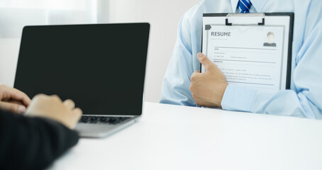 Business people hold a resume and talk to job applicants for job interviews about careers and Their...