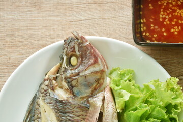 steamed mango fish with lettuce dipping spicy sauce on plate 