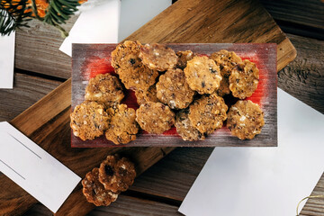 Gingerbread cookies. Rustic Christmas table decorated with wooden planks and red Christmas balls....