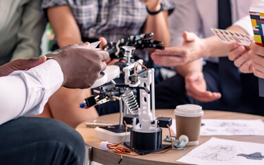 Selective focus on robot hand, AI which business people talking and discussing new business projects together in indoor office or workplace. Innovation, Technology, Business Concept.