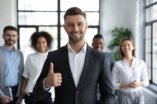 Portrait of smiling confident Caucasian businessman forefront shot thumb up give recommendation, happy motivated male leader boss recommend good company service, leadership, success concept