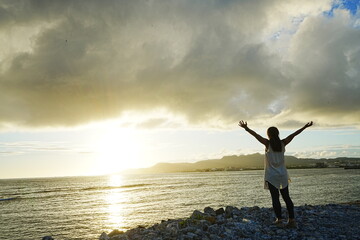 Woman With Open Arms on Sunset Beach in Nago, Okinawa, Japan - 日本 沖縄 名護...