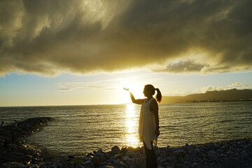 Woman seating in Sunset Image of Agarie Beach in Nago, Okinawa, Japan - 日本 沖縄 名護...