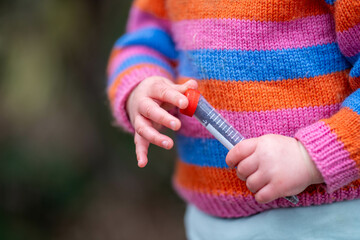 toddler with test tube learning science