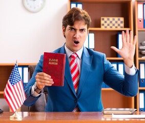 Young handsome politician sitting in office