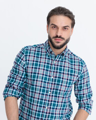 Fototapeta premium portrait of casual young man in plaid shirt looking forward and posing