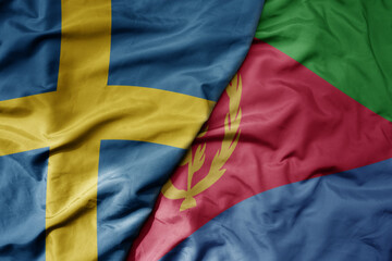 big waving national colorful flag of sweden and national flag of eritrea