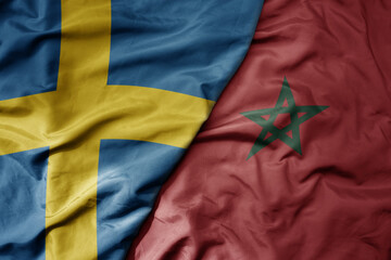 big waving national colorful flag of sweden and national flag of morocco .
