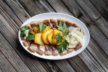 Herring with potatoes, cilantro, onions. Classic Russian dish. Top view