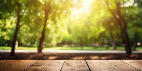 Spring summer beautiful nature background with blurred park trees in sunlight and empty wooden table