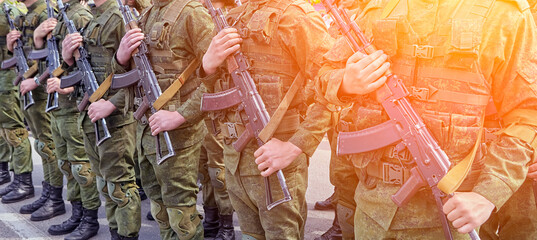 Soldiers shoulder to shoulder during the parade. - obrazy, fototapety, plakaty